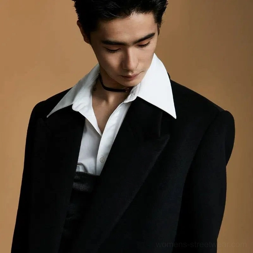Close-up black wool peak lapel overcoat with single-button closure, wide lapel, and refined Korean-inspired layered styling