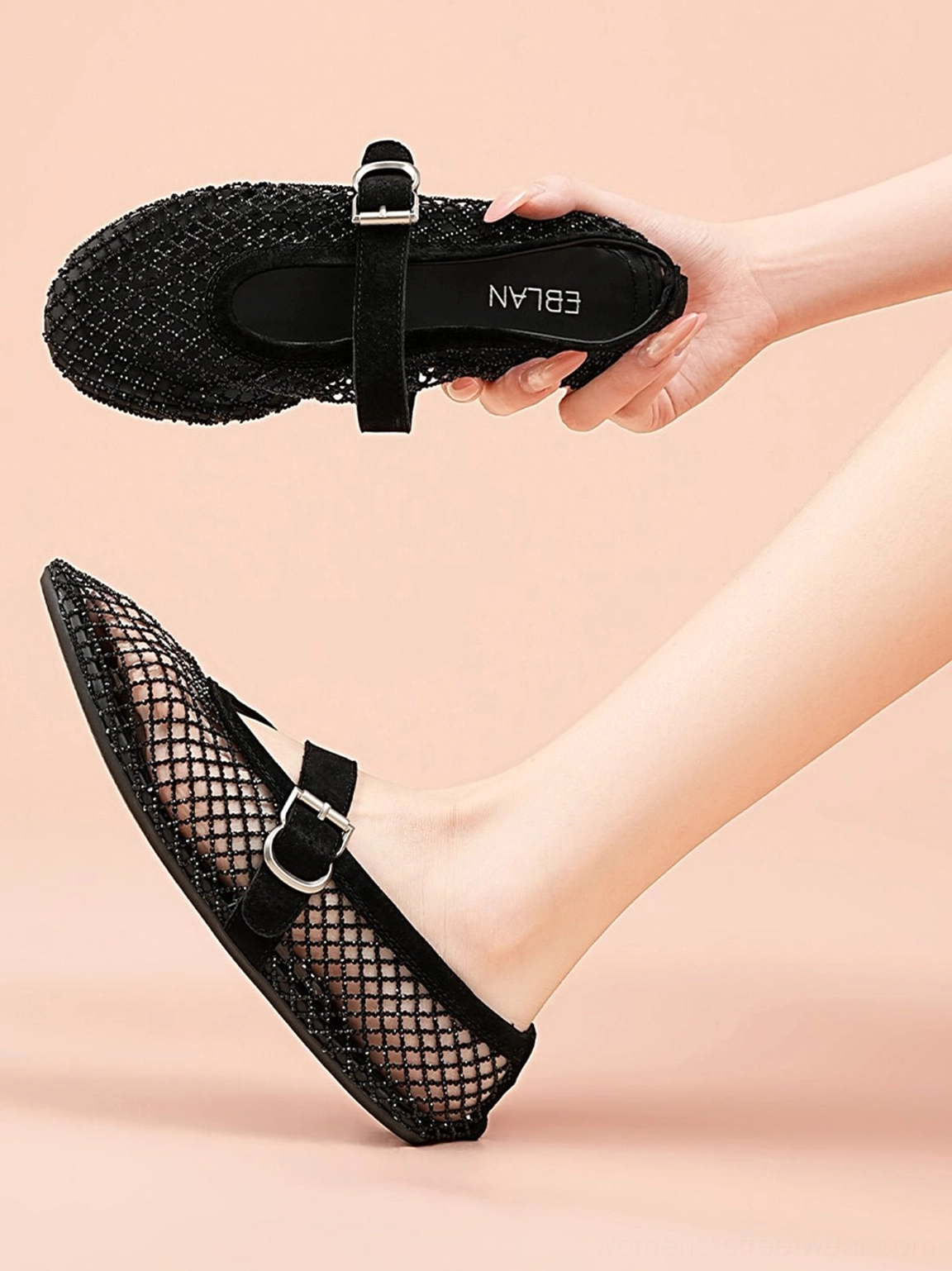 Black mesh Mary Jane flats held by model and worn in side view, highlighting the woven upper and silver buckle