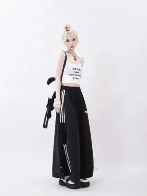 Black Y2K cargo maxi skirt with white side stripes shown from the left side, featuring utility pocket detail, side slit accent, and drawstring hem