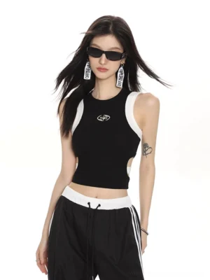 Black cropped ribbed tank top with white armhole binding side cutout and silver star emblem