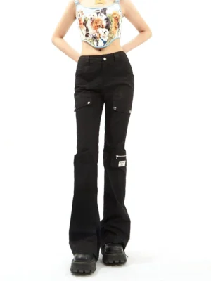 Front full-body view of black high-waisted flared cargo pants with multiple snap-button pockets, zippered thigh pocket, and Y2K streetwear silhouette