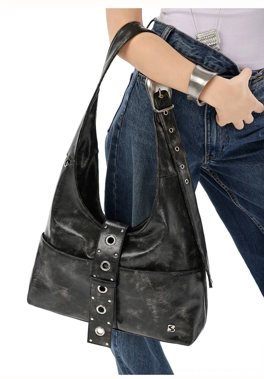 Side close-up of black Y2K hobo shoulder bag with adjustable eyelet strap and front pocket