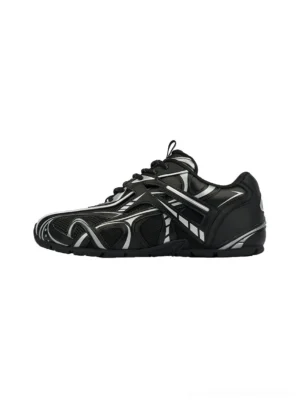 Black and off-white Yin-Yang techwear runner sneakers shown from a side three-quarter angle with layered overlays, silver racing stripes, and a futuristic retro streetwear silhouette