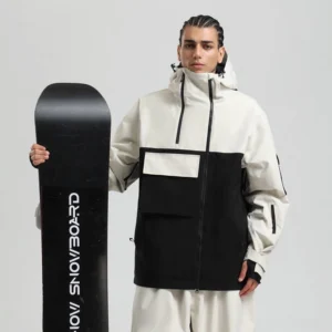 White and black block panel tech snowboard jacket worn with a snowboard in a streetwear studio look