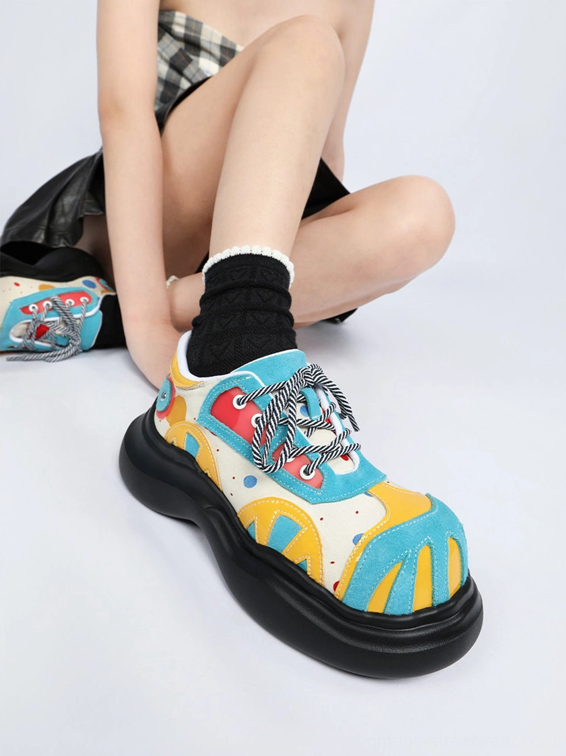 Blue abstract graphic platform derby shoes with rounded toe and sculpted black chunky sole worn with alternative streetwear