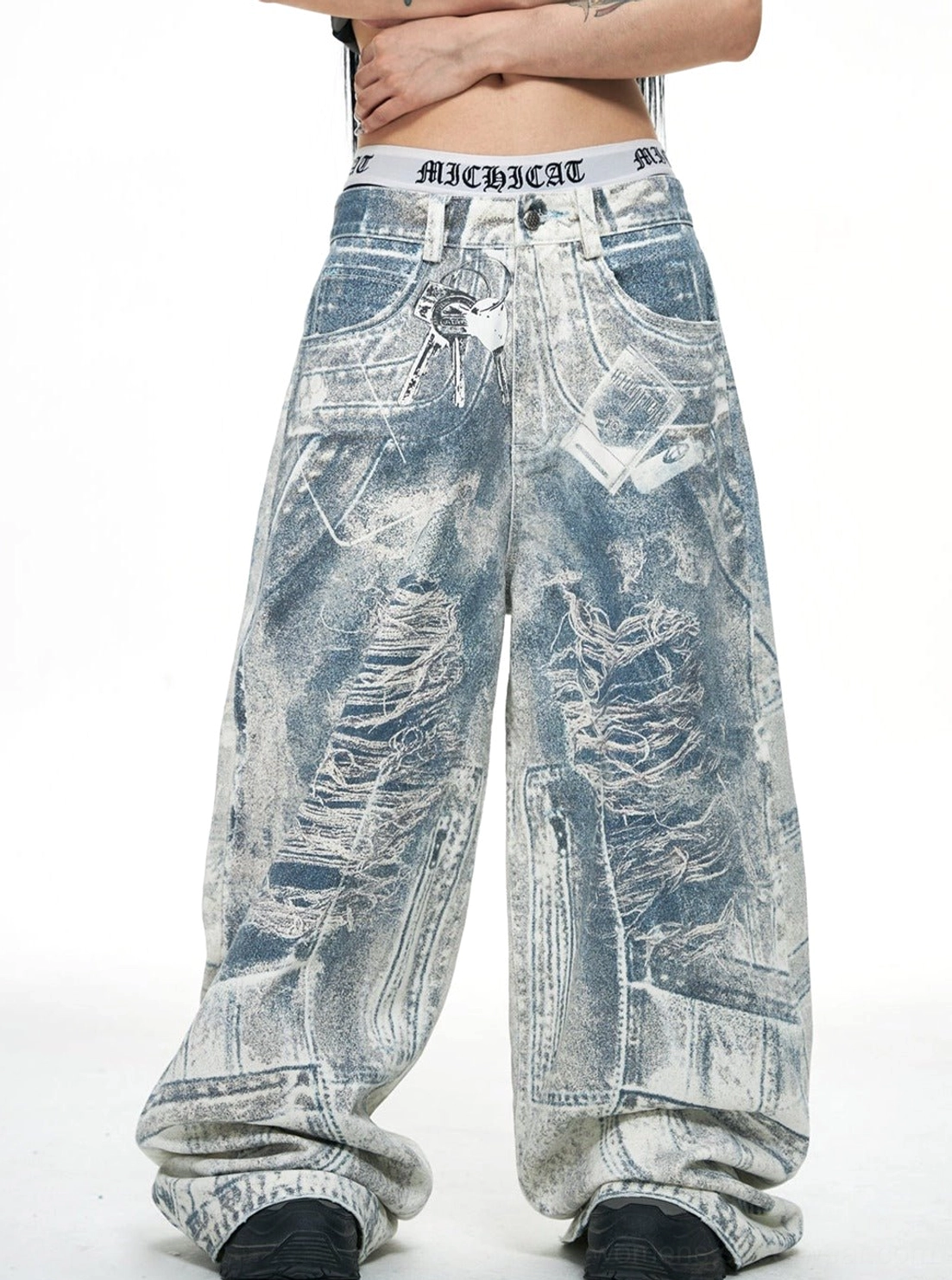 Front view of blue acid-wash baggy jeans showing ripped distressed texture, classic jean pockets, wide legs, and visible waistband detail