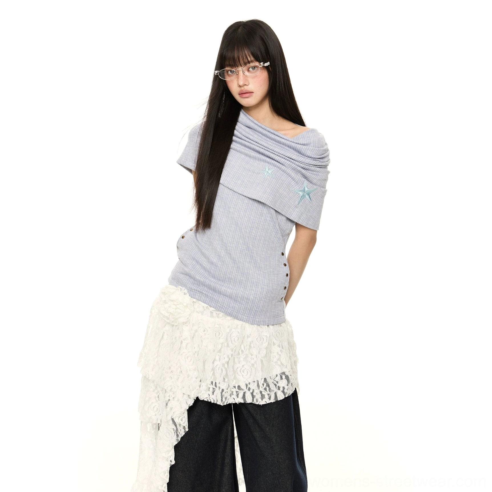 Blue asymmetric off-shoulder star embroidered pinstripe knit top back three-quarter view styled with lace hem skirt and wide-leg jeans