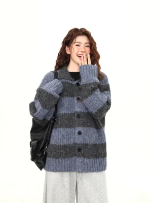 Blue and charcoal wide-stripe fuzzy knit cardigan shown from the front with oversized relaxed fit, button closure, and gray wide-leg streetwear trousers