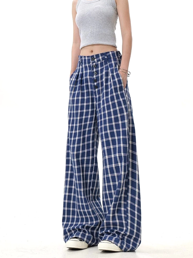 Blue checkered high-waisted wide-leg pants shown with functional side pockets and relaxed streetwear silhouette