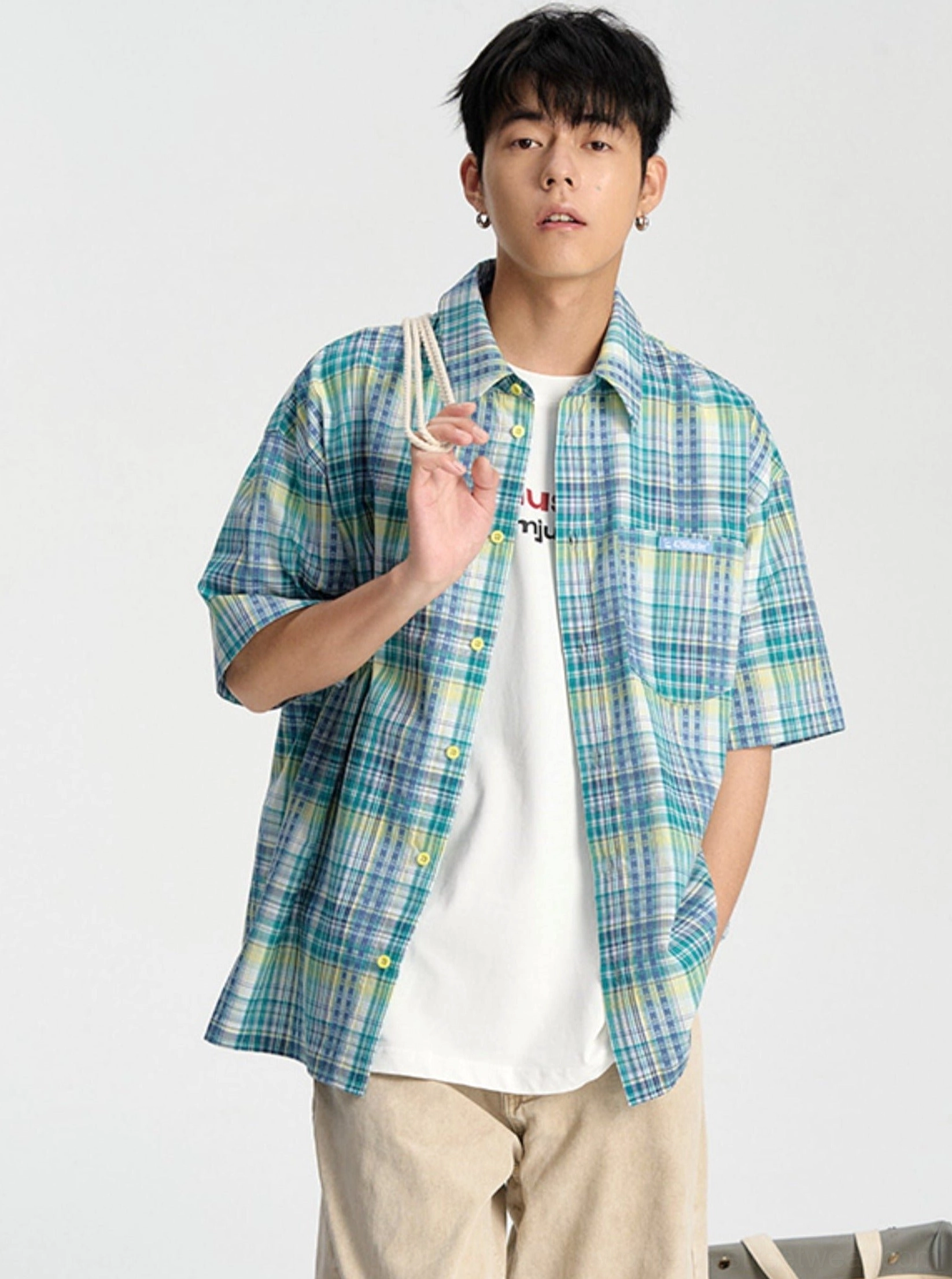 Blue checkered short sleeve button-down shirt styled with a white T-shirt in a casual Seoul streetwear outfit