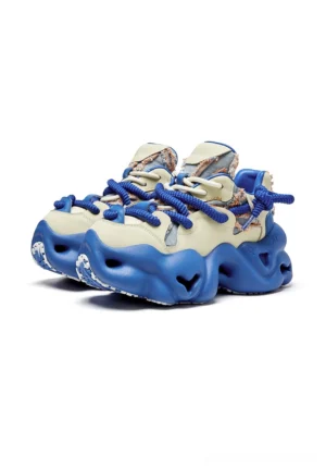 Blue and cream chunky dad sneakers with sculpted platform sole, layered panels, thick blue rope laces, and bold streetwear color blocking