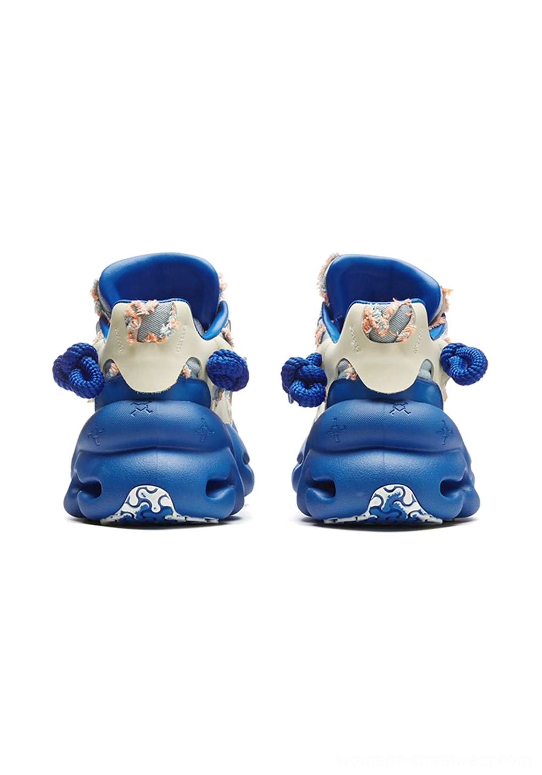 Rear view of blue and cream chunky sneakers showing royal blue heel sole, cream heel cap, and decorative heel accents