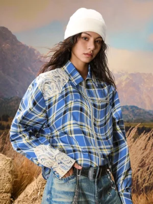Blue deconstructed lace trim plaid zip-up unisex streetwear shirt jacket worn by female model in an outdoor hayfield