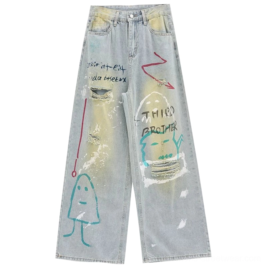 Flat lay view of blue distressed graffiti wide-leg jeans with high waist, acid-wash finish, painted lettering, cartoon artwork, and ripped details