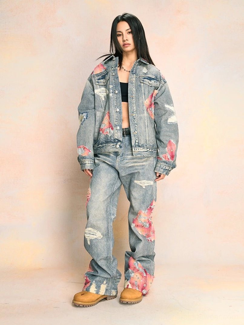 Rear view of blue distressed wide-leg jeans showing pink frayed hem details, ripped denim accents, and back pocket styling