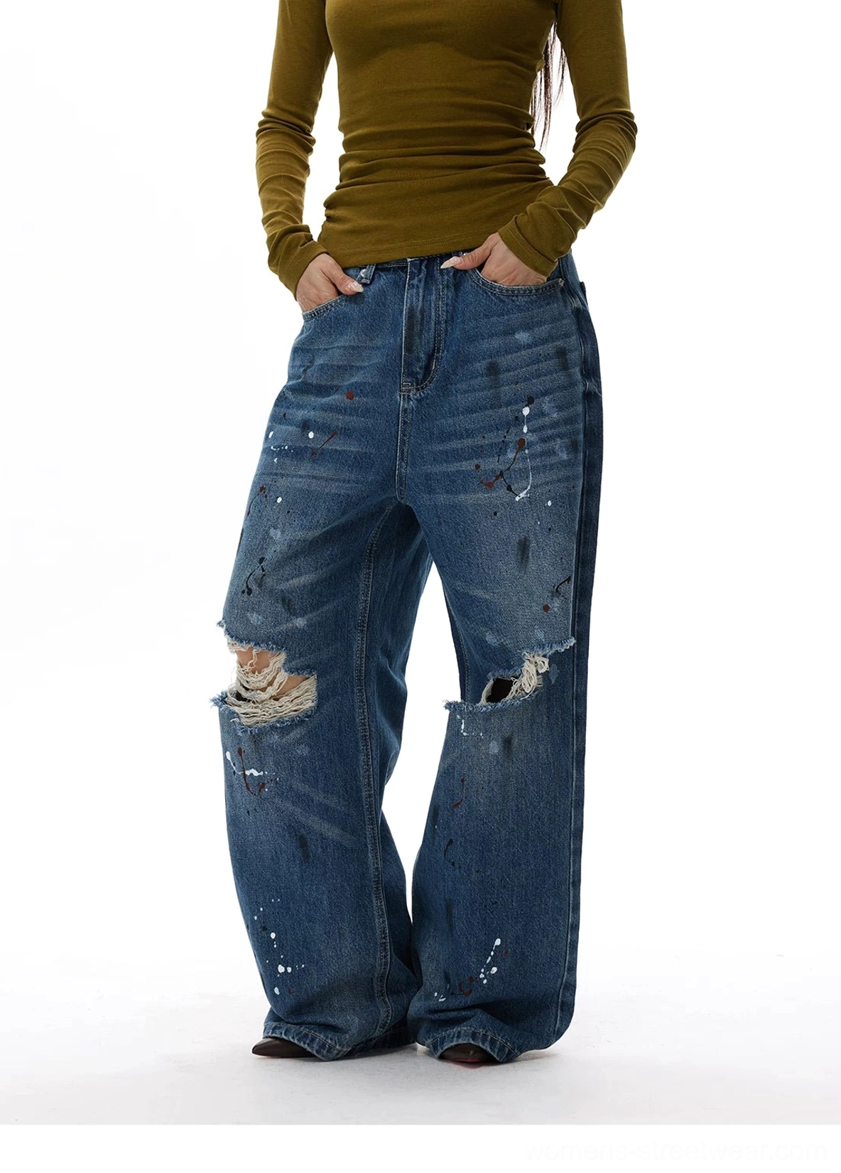 Blue distressed wide-leg streetwear jeans featuring frayed knee rips, faded whiskering, and artistic paint accents