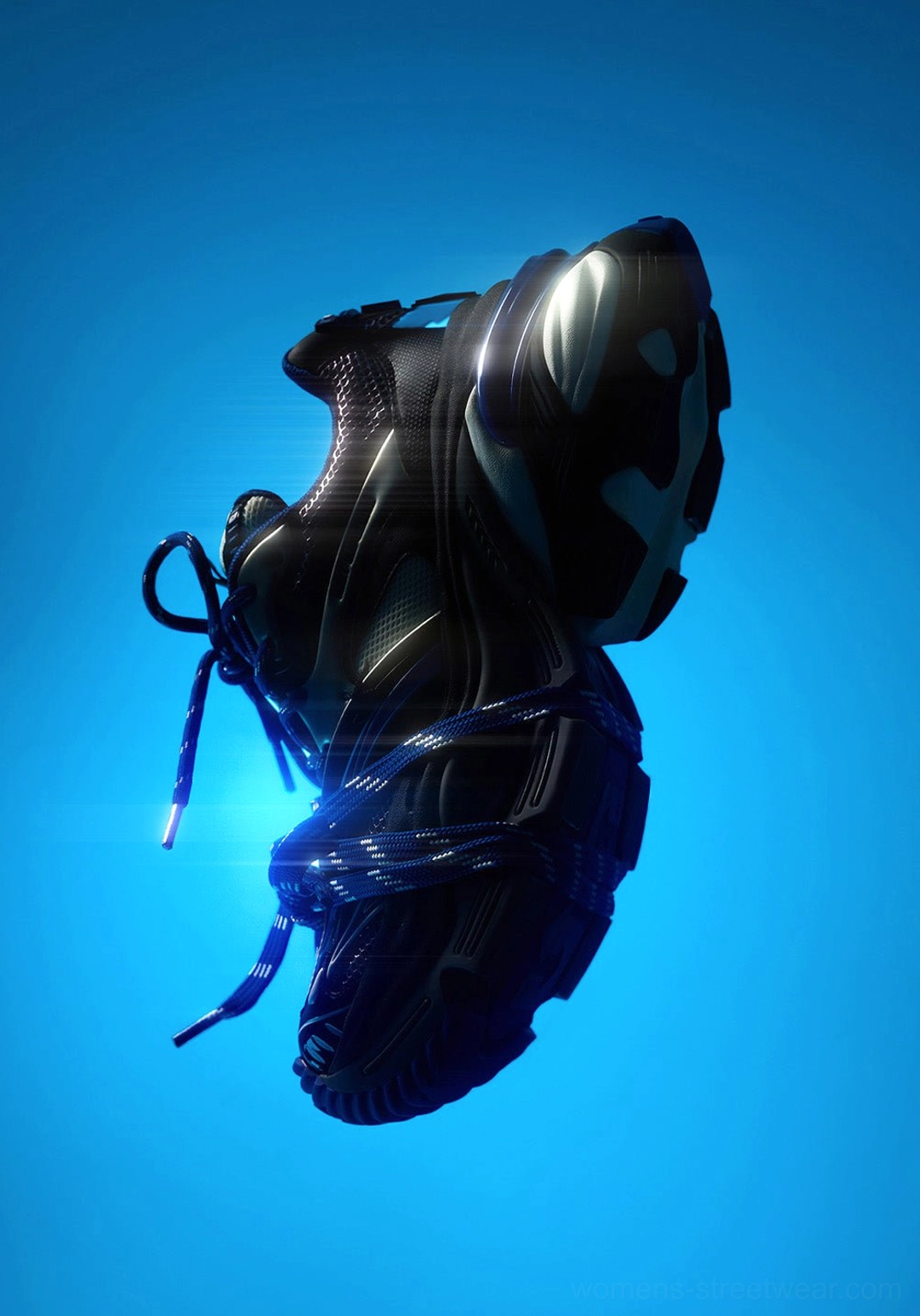 Blue futuristic chunky platform sneaker shown from a low rear-side angle with a sculptural heel, dark tonal panels, and glowing-looking sole highlights