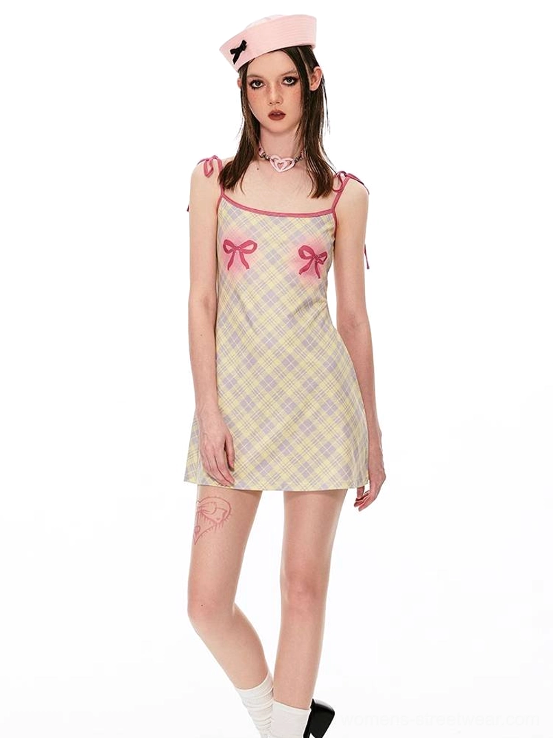 Blue gingham mini dress with angel graphic print, red tie straps, and cute Seoul fashion aesthetic