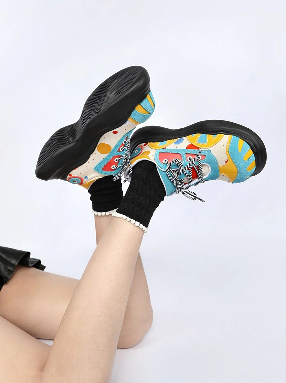 Bottom and rear view of blue graffiti graphic platform derby shoes with black platform outsole and frilled socks