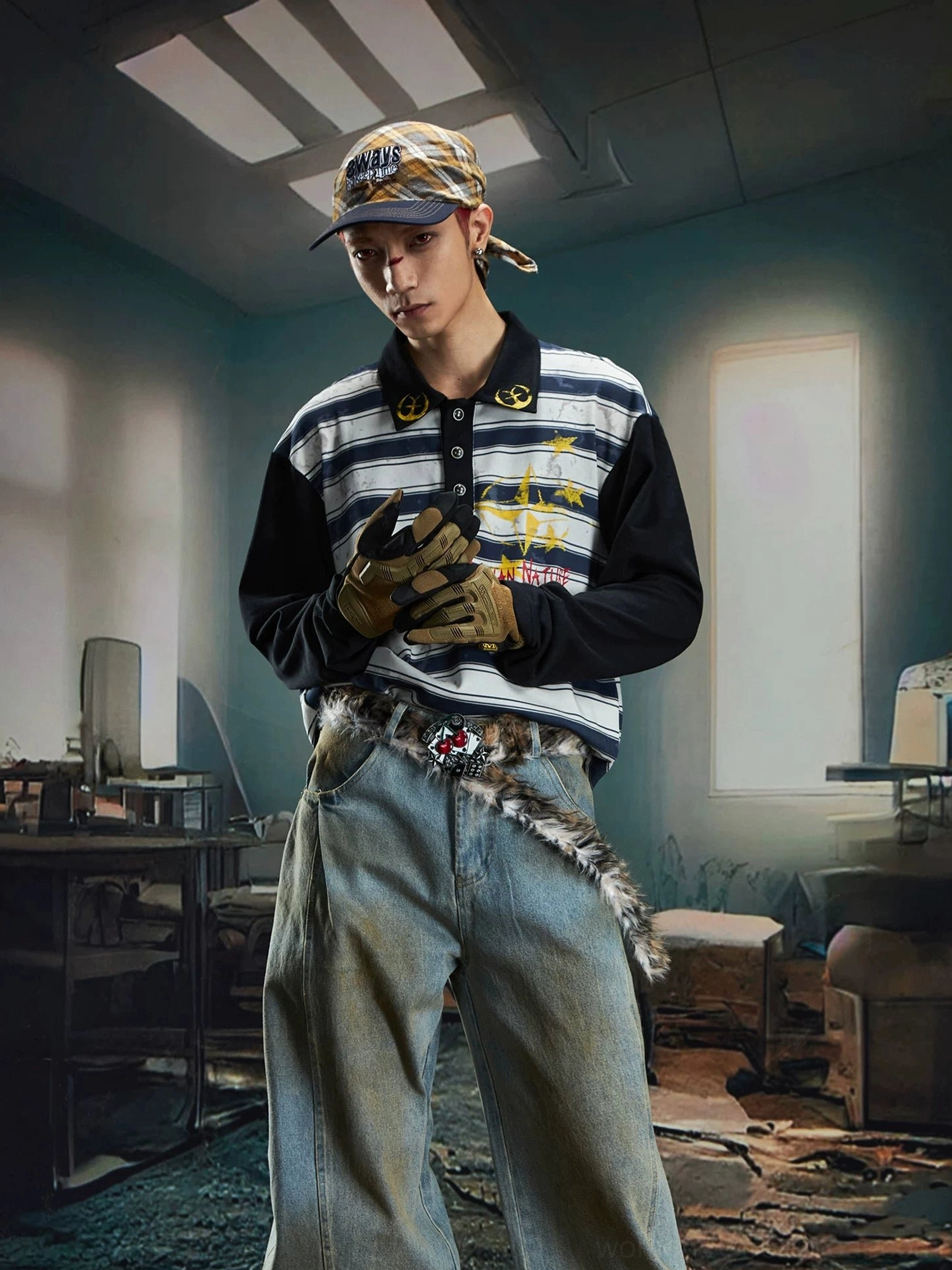 Front three quarter male streetwear outfit featuring a blue grey striped rugby polo shirt, light wash baggy jeans, baseball cap, and fur waist chain
