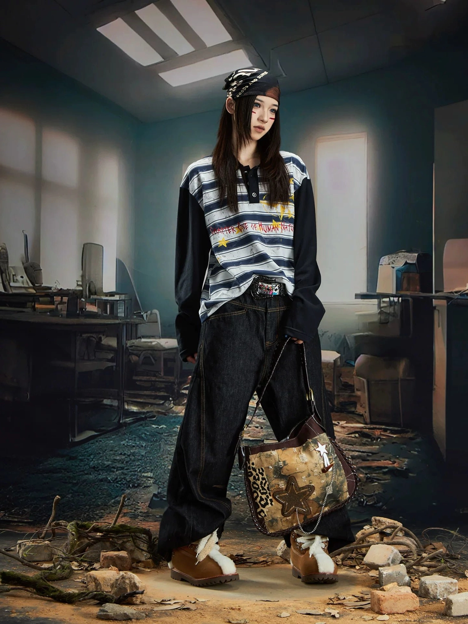 Back three quarter view of a female model in a blue grey striped rugby polo shirt styled with dark baggy jeans and brown casual sneakers