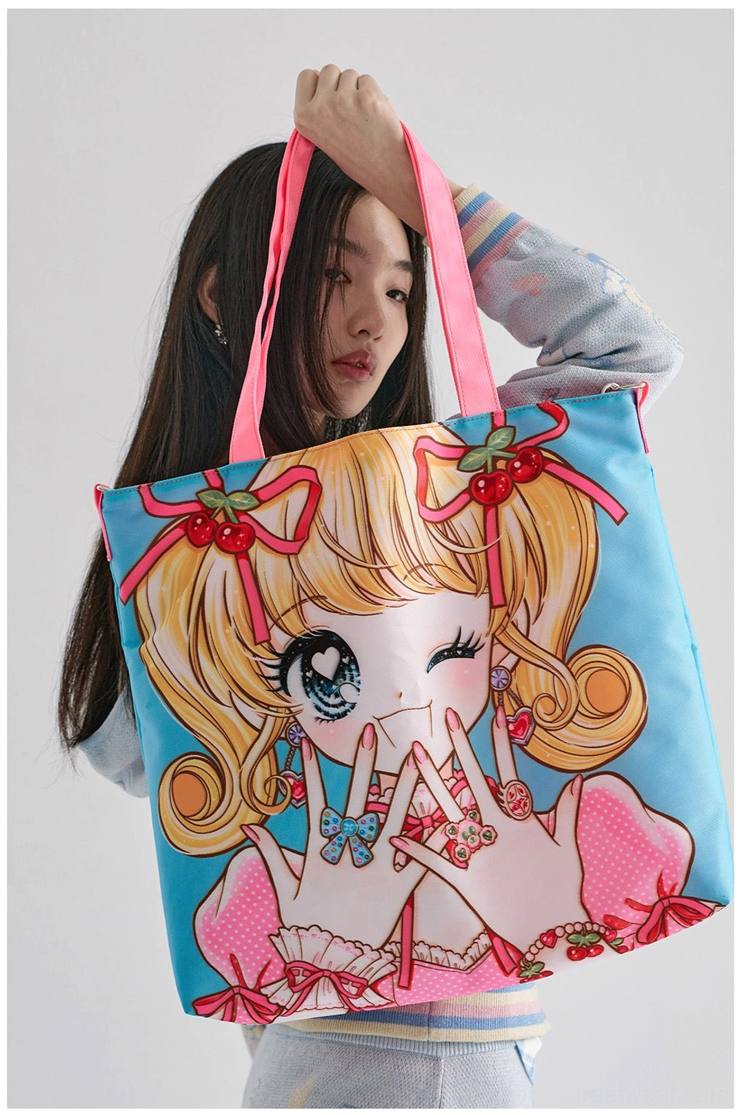 Sky blue kawaii anime girl printed tote bag with hot pink straps styled as a Y2K crossbody streetwear accessory
