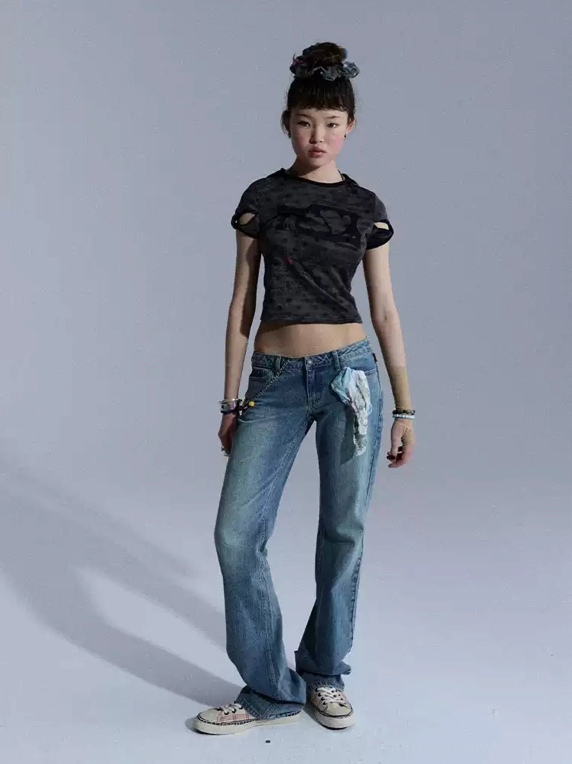 Front full-body styling view of blue low-rise slim flare denim jeans with fitted thigh and subtle flared leg opening