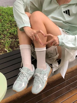 Model wearing blue mesh star German trainer sneakers with white crew socks in a casual streetwear outfit