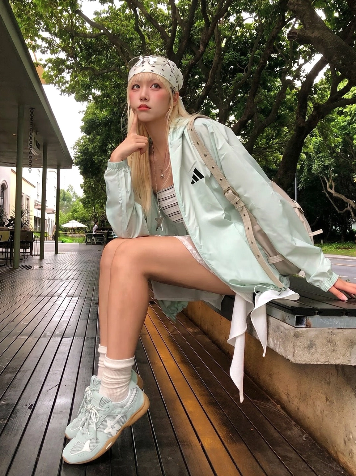Blue mesh star German trainer sneakers worn outdoors with a light casual streetwear outfit on a cafe patio
