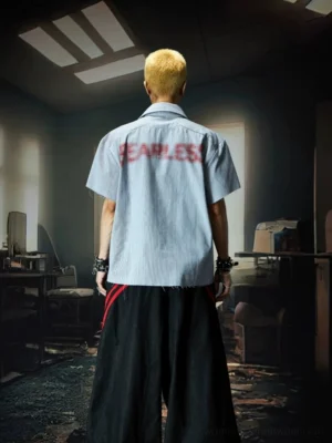 Back view of blue pinstripe graffiti camp collar streetwear shirt with oversized red spray style slogan print