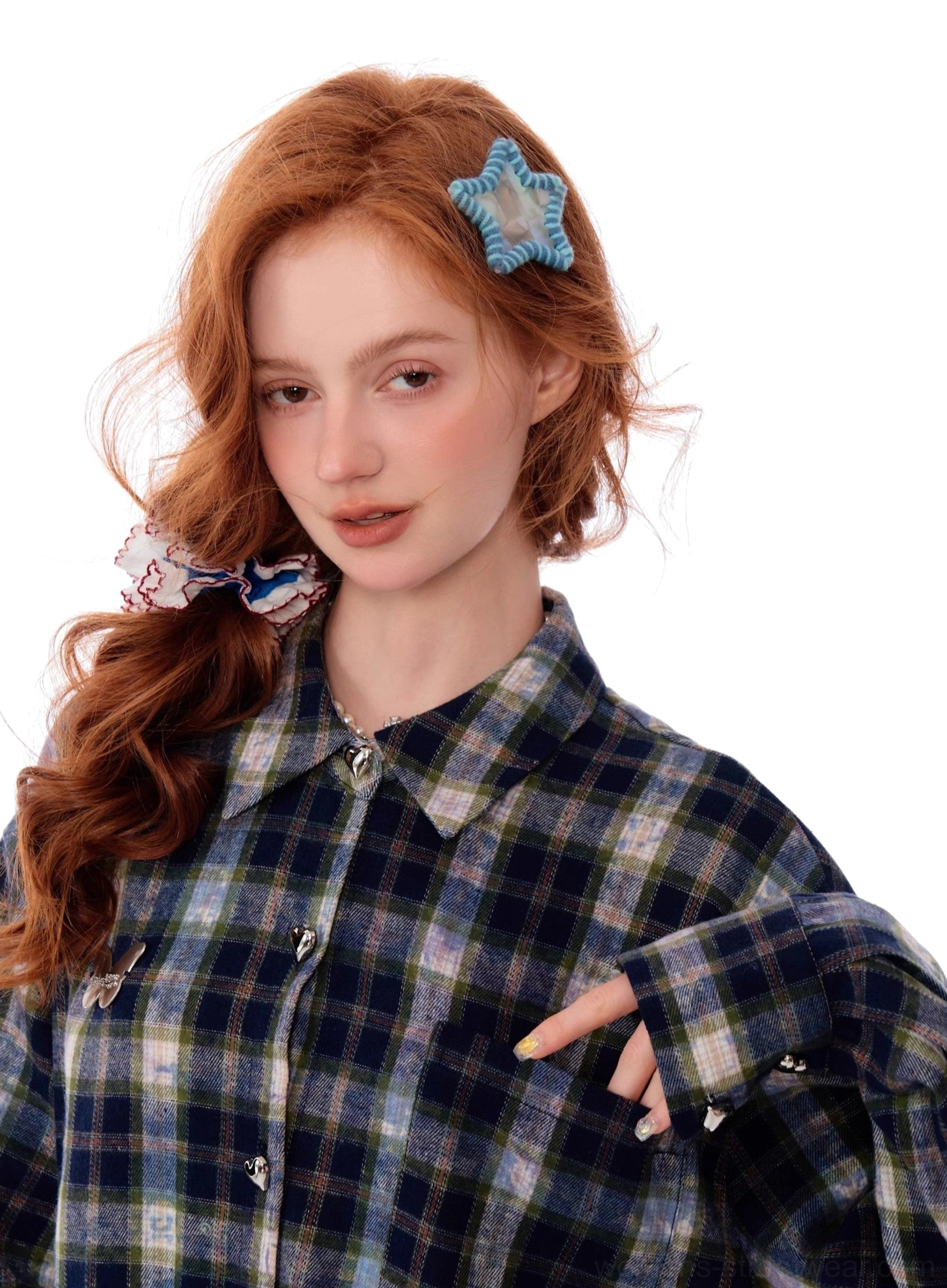 Close-up detail of blue plaid button-up shirt collar, round metal buttons, woven check fabric, and lace hem