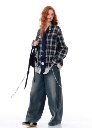 Side profile of a blue plaid lace hem button-up shirt styled with casual sneakers and a chain shoulder bag