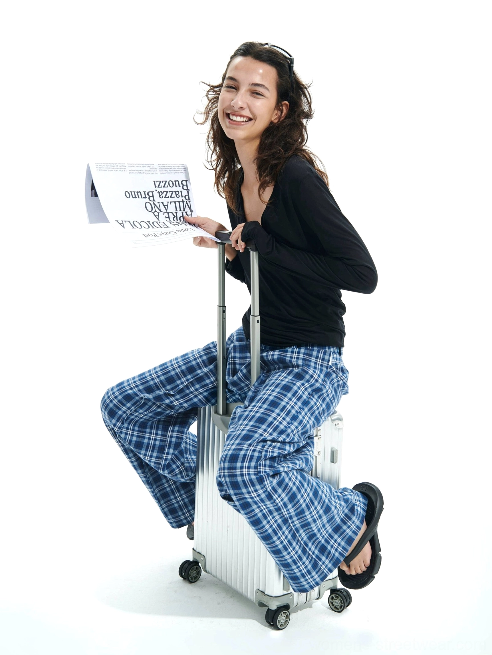 Blue plaid relaxed wide-leg pants styled for casual city travel with a loose silhouette and comfortable tartan print