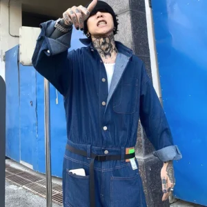 Blue relaxed denim coverall jumpsuit front view with adjustable waist belt, rolled cuffs and wide straight legs