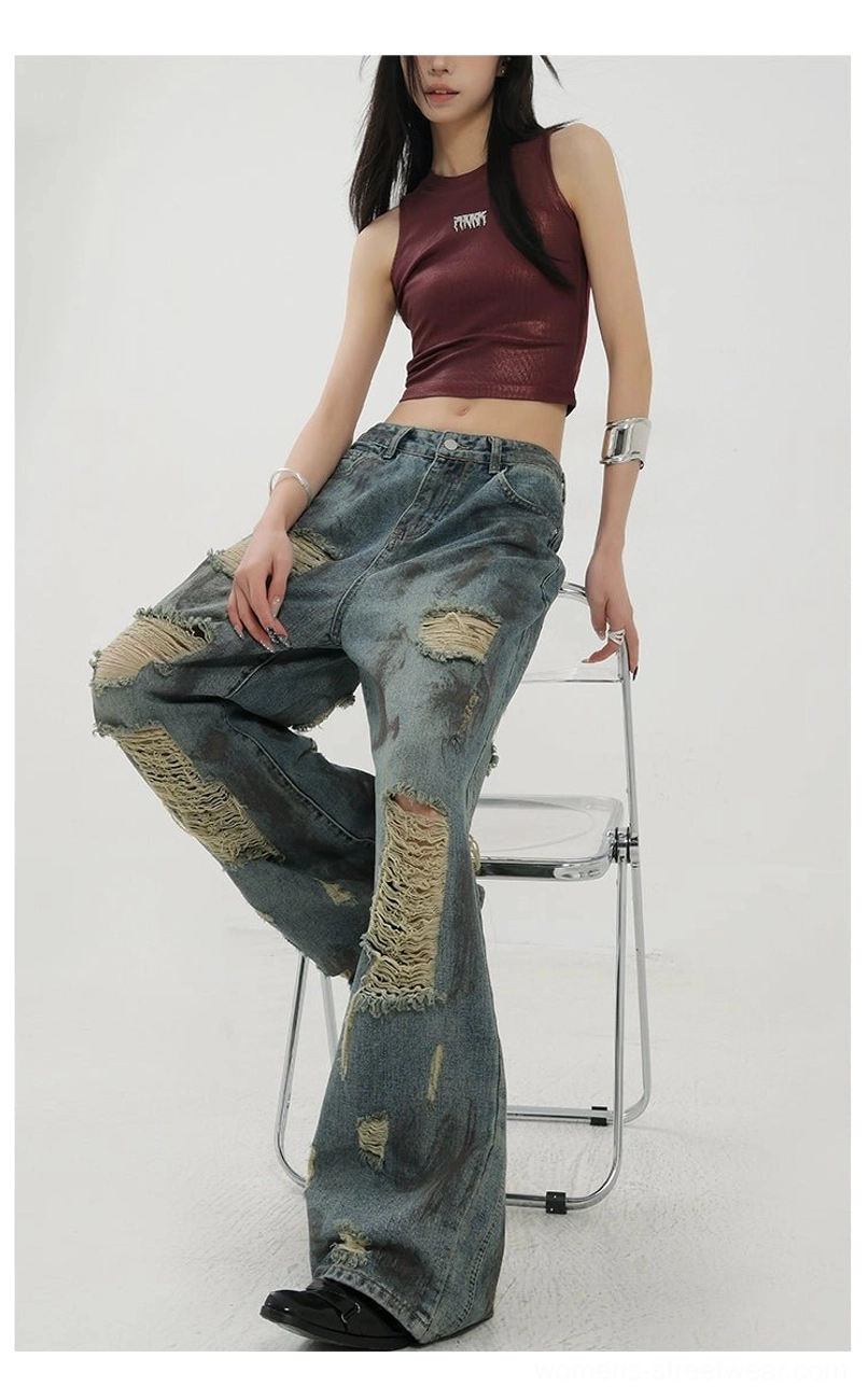 Blue retro distressed jeans with a flowing wide-leg silhouette, shredded patches, and relaxed everyday fit