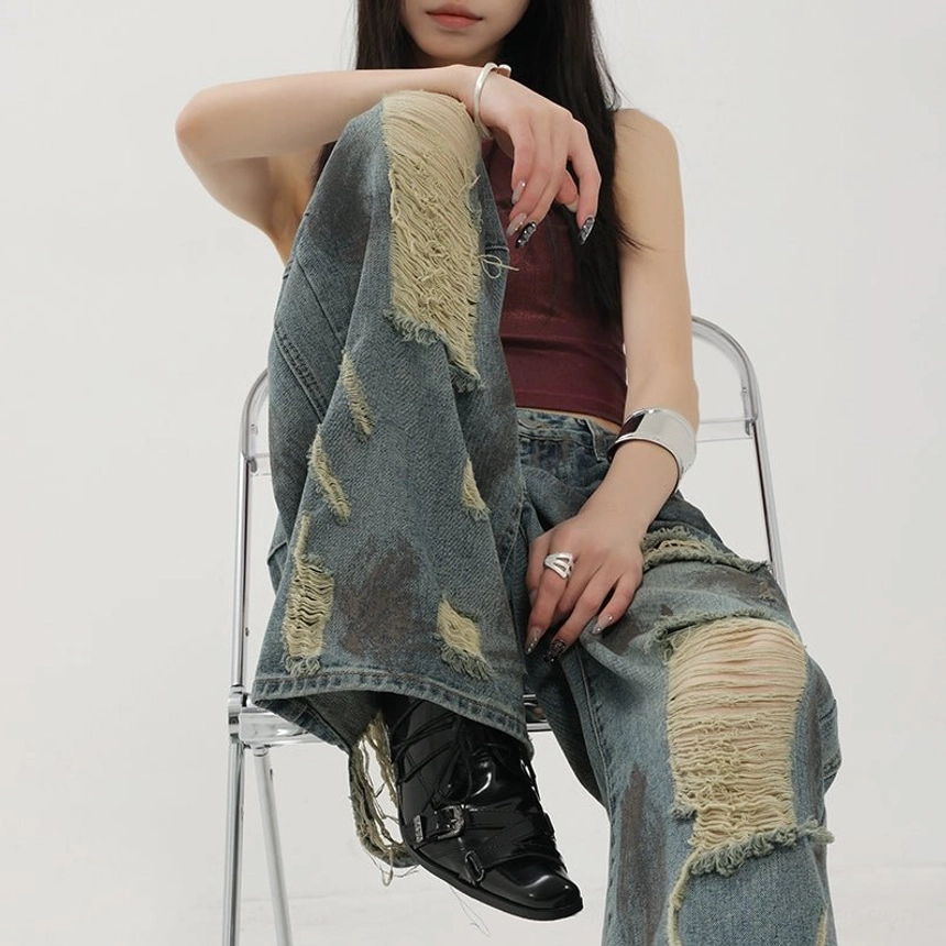 Blue retro tie-dye distressed wide-leg jeans with washed vintage finish and relaxed draping streetwear fit