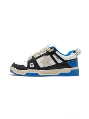 Blue retro low-top streetwear sneakers in a side view with black white cream and royal blue color-blocked panels, thick cream laces and embroidered side detail