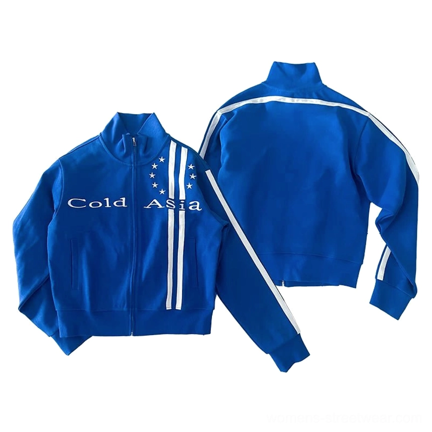 Flat lay front and back view of a blue starstripe track jacket showing the front graphic text, sleeve trims, single white back stripe, and cropped sporty silhouette