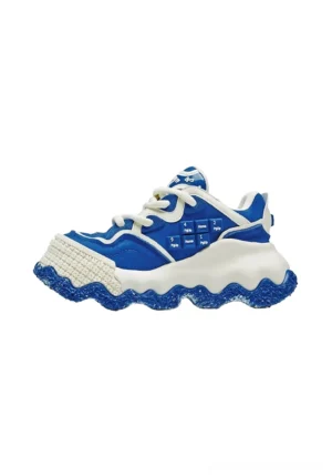 Blue and white colorblock chunky sole sneaker side profile with layered leather-look upper, decorative side studs, lace-up closure, and speckled wavy blue outsole