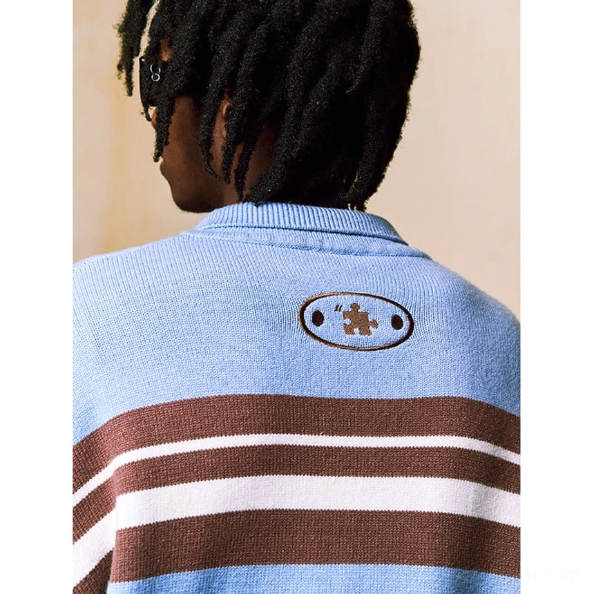 Close-up back detail of blue striped embroidered polo knit sweater with oval patch