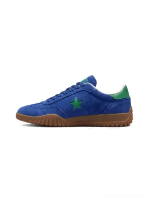 Blue suede star embroidered retro streetwear sneakers with green heel accent and gum rubber sole side profile