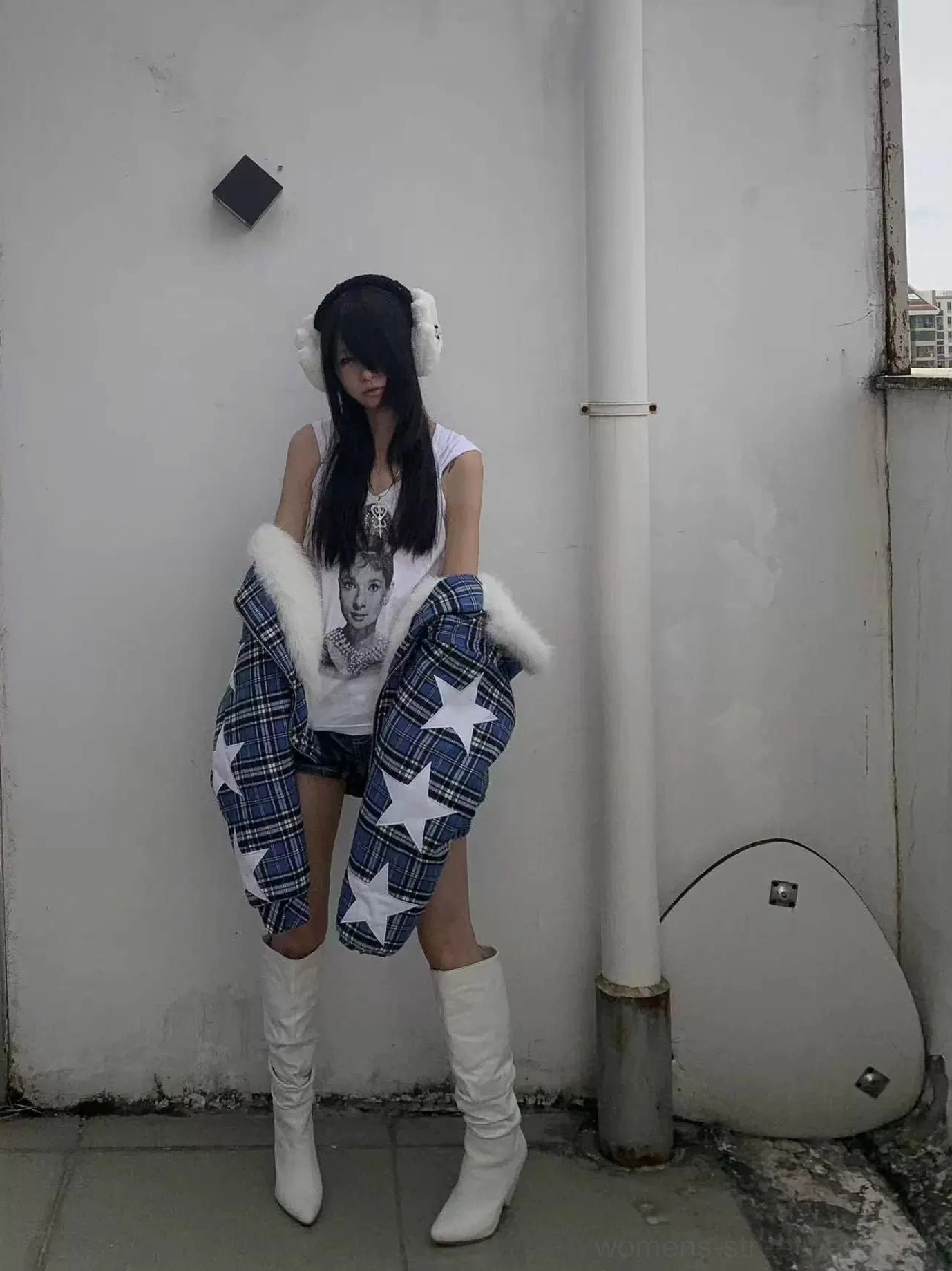 Blue tartan puffer jacket with white star details and plush faux-fur hood styled with white boots for a Korean streetwear winter outfit