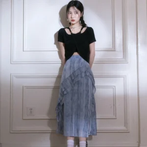 Front full-body view of blue tie-dye ruffle cascade maxi skirt with ankle-length flowing silhouette and black cutout crop top