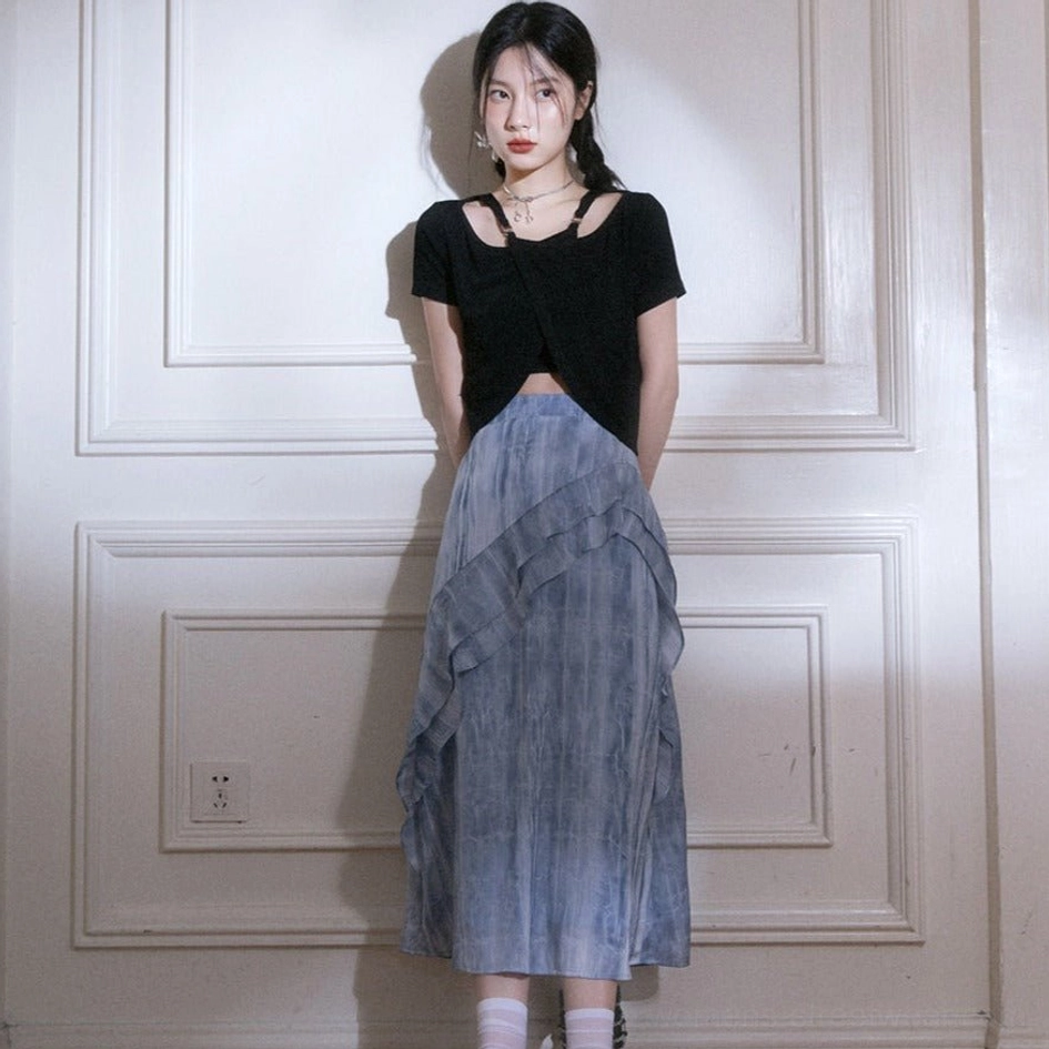 Front full-body view of blue tie-dye ruffle cascade maxi skirt with ankle-length flowing silhouette and black cutout crop top