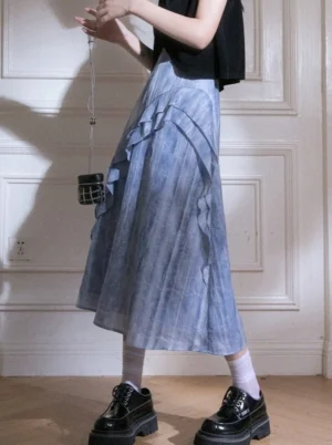 Blue tie-dye ruffle cascade streetwear maxi skirt shown in a left side low-angle outfit view with black crop top and platform shoes