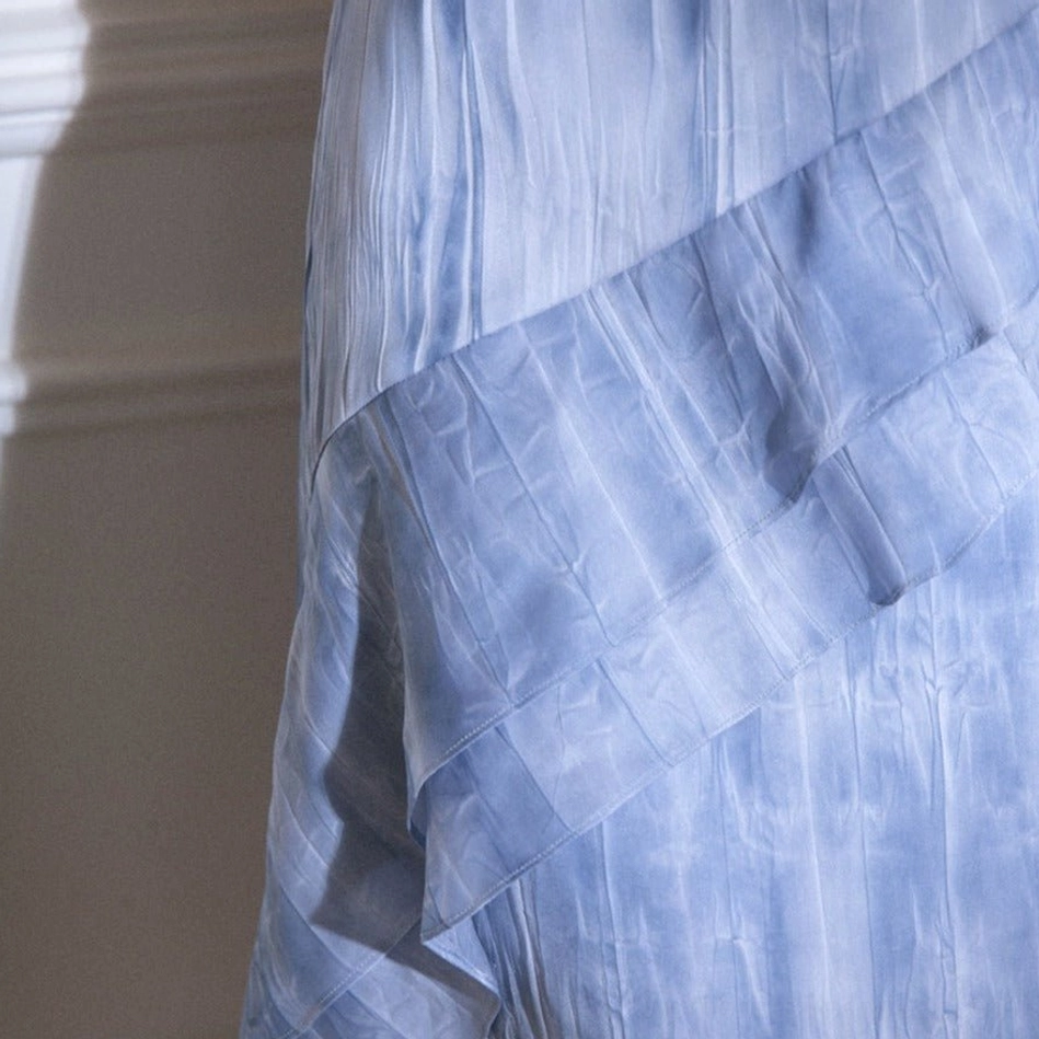 Blue tie-dye ruffle cascade streetwear maxi skirt product view featuring the ankle-length flowing design and watercolor blue print