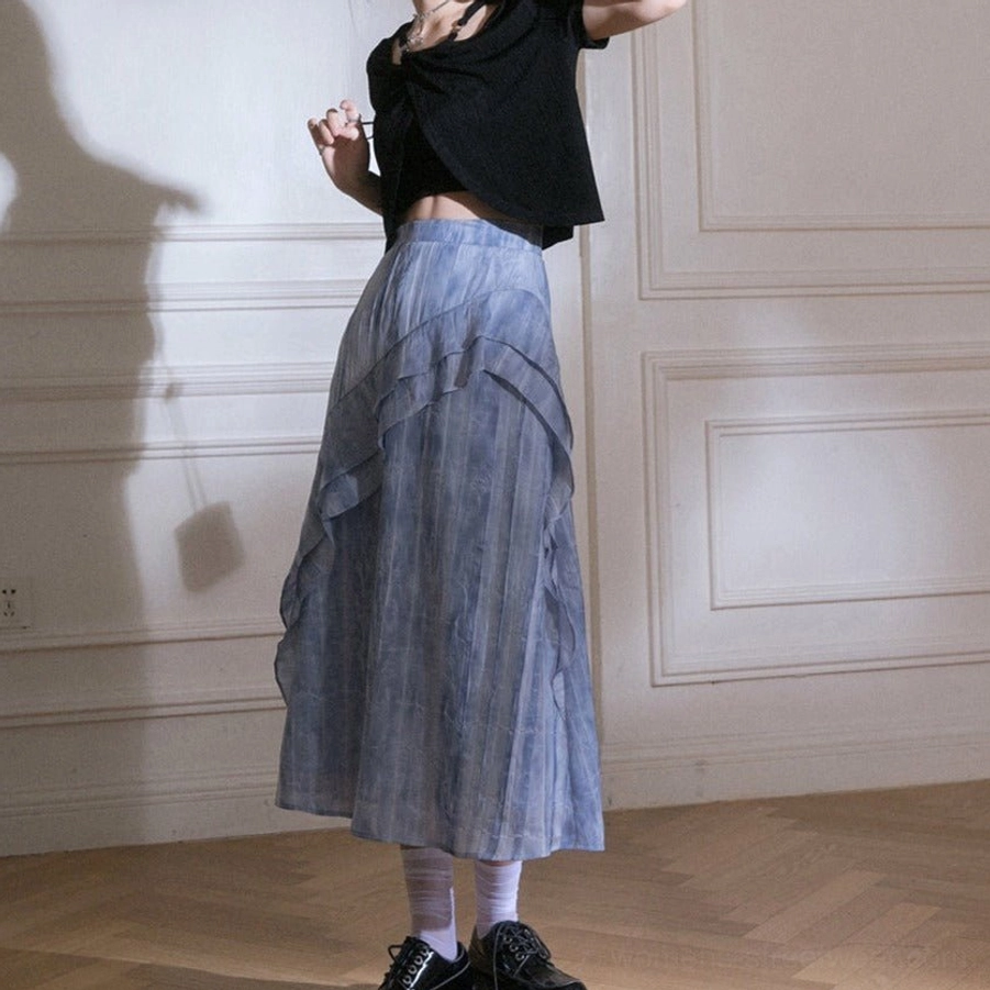 Right side view of blue tie-dye ruffle cascade streetwear maxi skirt showing asymmetric layered ruffle overlay and fluid drape