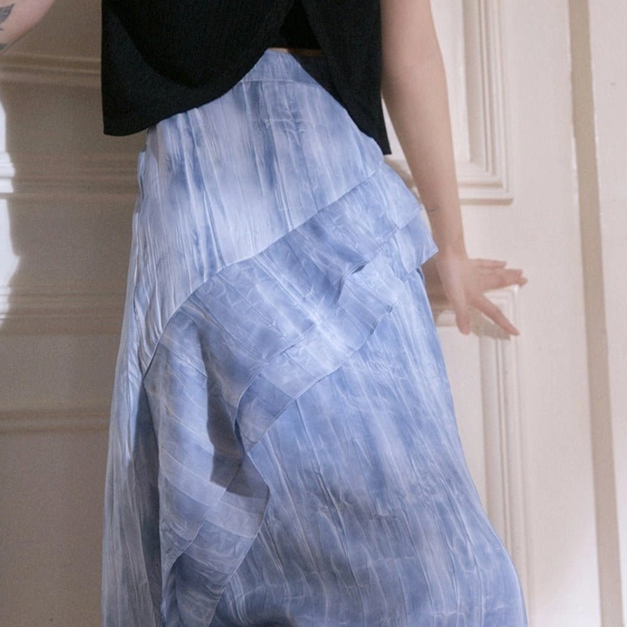 Side close-up of blue tie-dye ruffle cascade maxi skirt highlighting the watercolor gradient print and soft layered trim