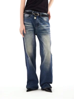 Front full-body view of blue vintage wash high-rise wide-leg jeans styled with a black tee, oval buckle belt, and pointed flats
