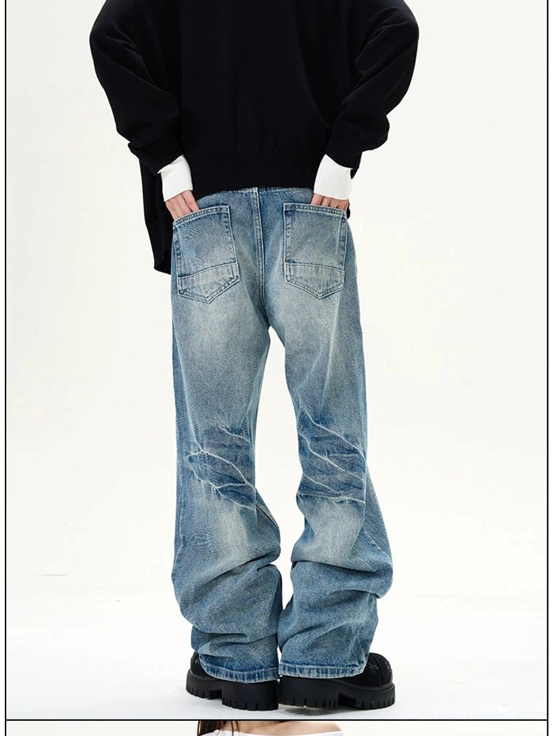 Rear view of blue wash wide-leg jeans with distressed denim creasing and classic back pocket stitching